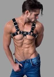 Man wearing a male bondage harness styled with jeans, showcasing how to pair bold harness fashion with casual outfits.
